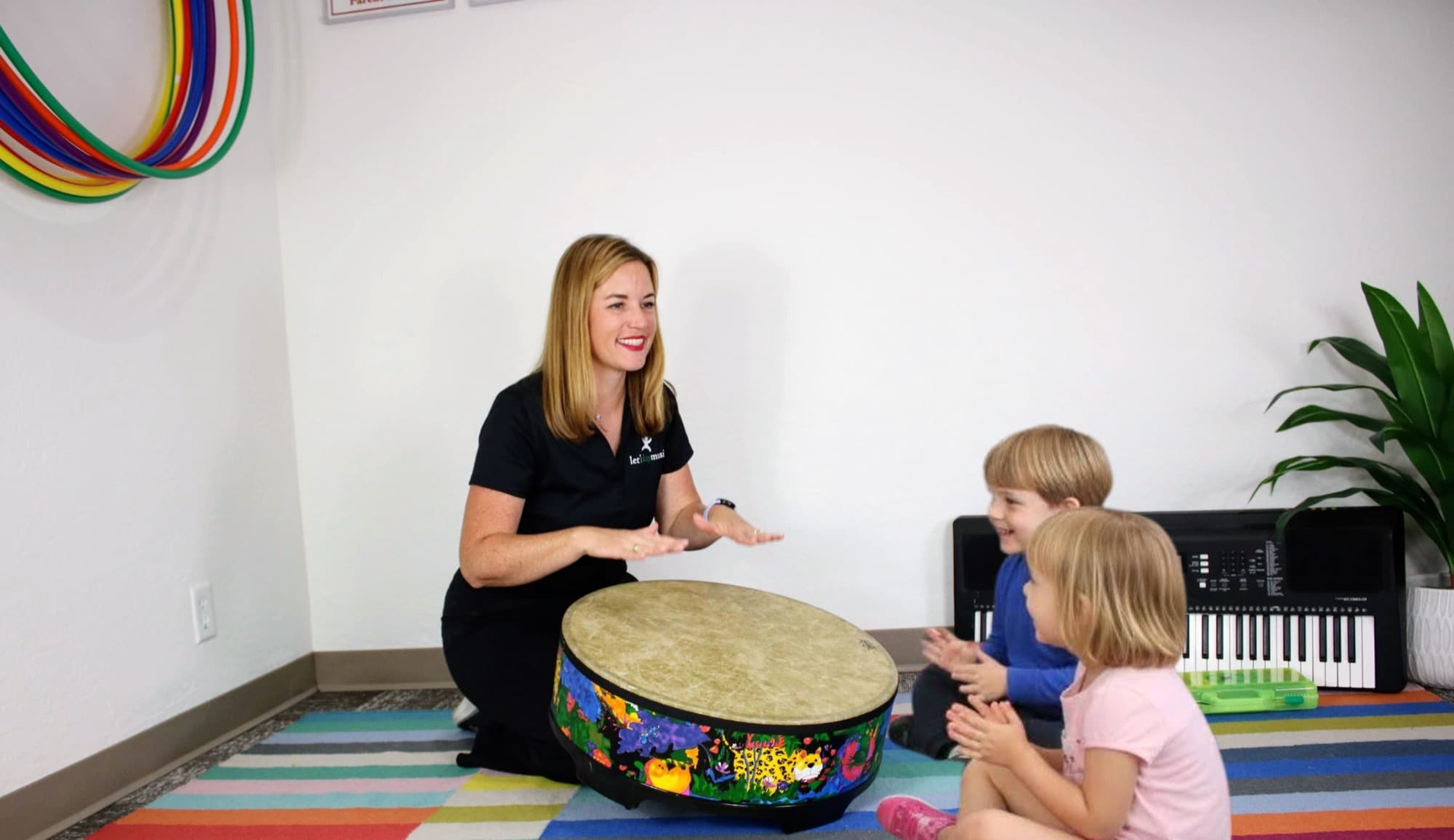 Ms. Abigail making music with children in her studio
