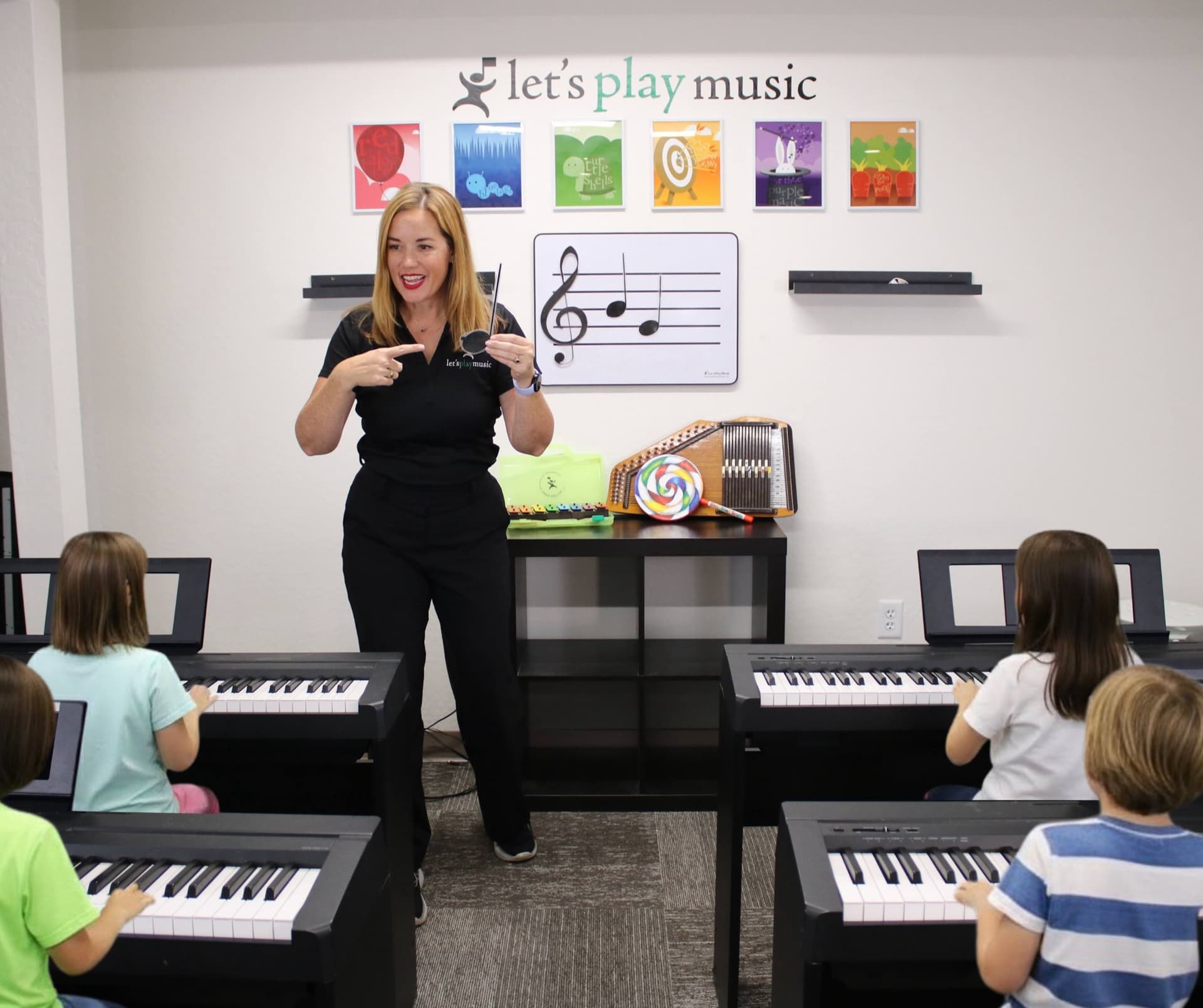 Children playing keyboards in the studio